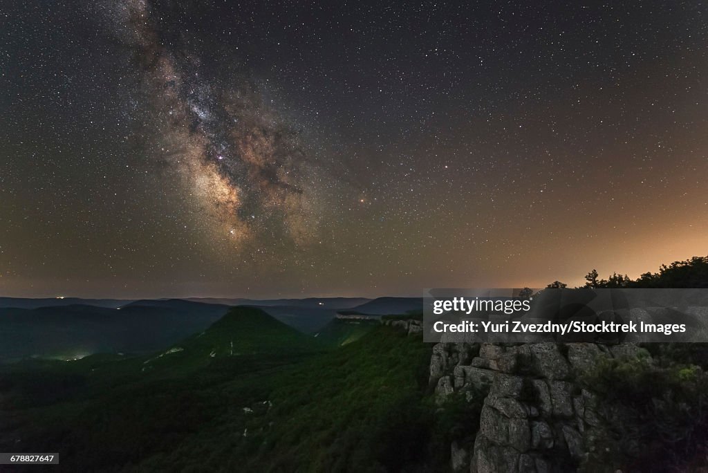 Milky Way over the forest covered mountains in Crimea.