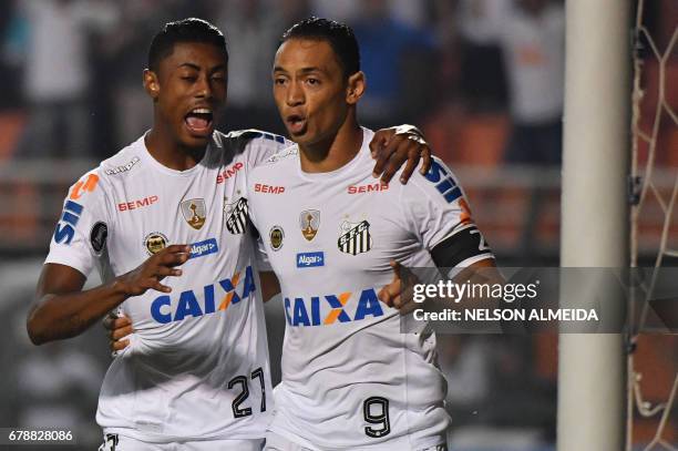 Ricardo Oliveira of Brazils Santos, celebrates his goal against Colombias Santa Fe with teammate Bruno Henrique during their 2017 Copa Libertadores...