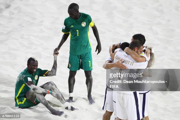 Ibrahima Balde and Babacar Fall of Senegal look dejected as Michele Di Palma, Matteo Marrucci and Dario Ramacciotti of Italy celbrate after the FIFA...