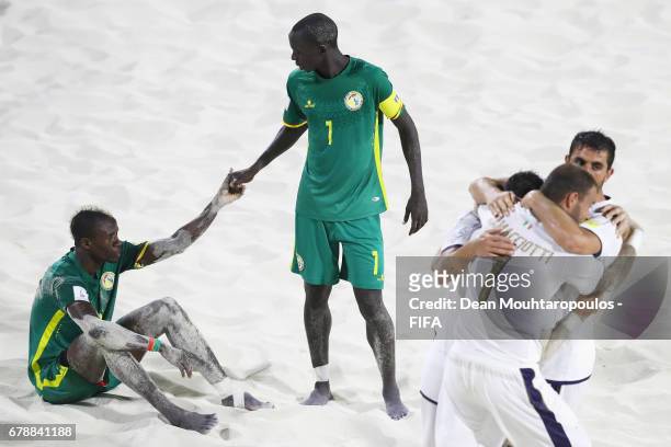 Ibrahima Balde and Babacar Fall of Senegal look dejected as Michele Di Palma, Matteo Marrucci and Dario Ramacciotti of Italy celbrate after the FIFA...