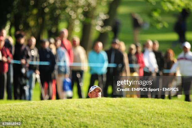 England's Lee Westwood peers out of a deep bunker as he watches an approach shot during Day One of the 2013 BMW PGA Championship, at Wentworth Golf...