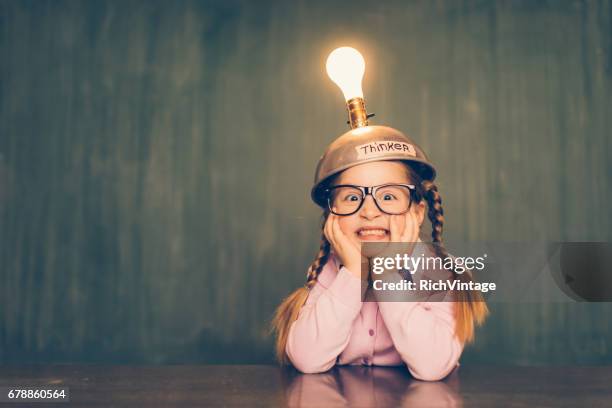 young nerd girl with thinking cap - spiritual enlightenment stock pictures, royalty-free photos & images