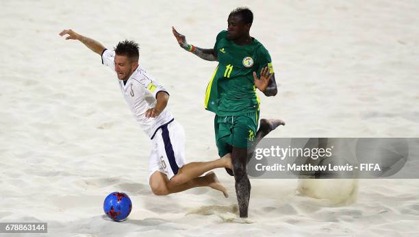 Ibrahima Balde of Senegal tackles Simone Marinai of Italy during the FIFA Beach Soccer World Cup Bahamas 2017 quarter final match between Italy and...