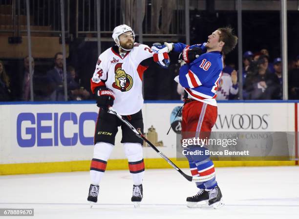 Viktor Stalberg of the Ottawa Senators and J.T. Miller of the New York Rangers battle during the third period in Game Four of the Eastern Conference...