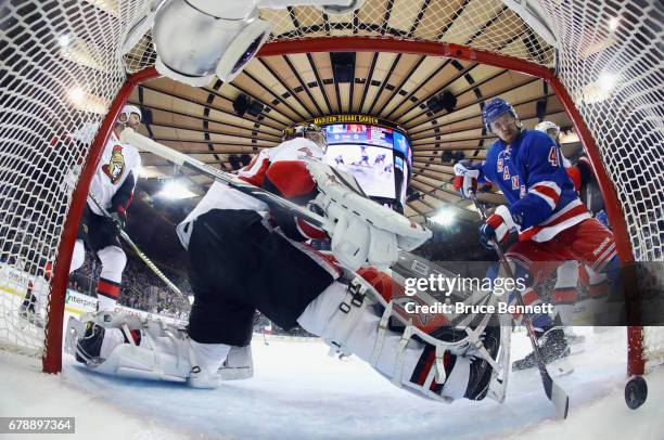 Michael Grabner of the New York Rangers watches a first period shot by Nick Holden go past Craig Anderson of the Ottawa Senators in Game Four of the...