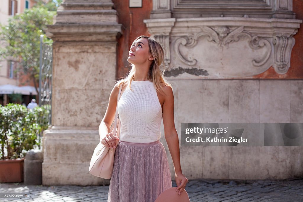 Beautiful woman walking on cobblestone street