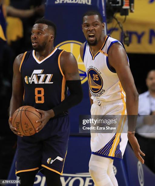 Kevin Durant of the Golden State Warriors reacts against Shelvin Mack of the Utah Jazz during Game Two of the NBA Western Conference Semi-Finals at...