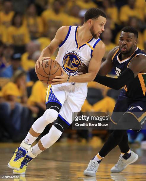 Stephen Curry of the Golden State Warriors looks to drive against Shelvin Mack of the Utah Jazz during Game Two of the NBA Western Conference...