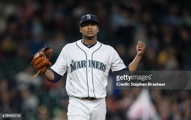 Starting pitcher Ariel Miranda of the Seattle Mariners reacts as he walks off the field after pitching the seventh inning game against the Los...