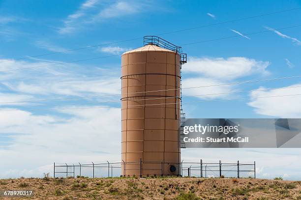 sand colored water tower in the desert - water tower storage tank stock pictures, royalty-free photos & images