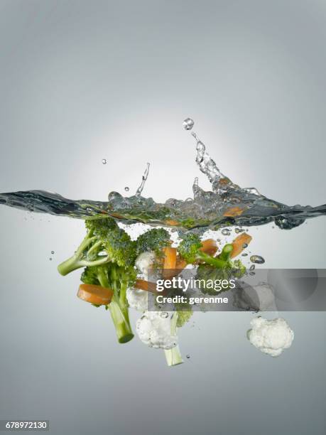 splashes and vegetables - salad tossing stock pictures, royalty-free photos & images