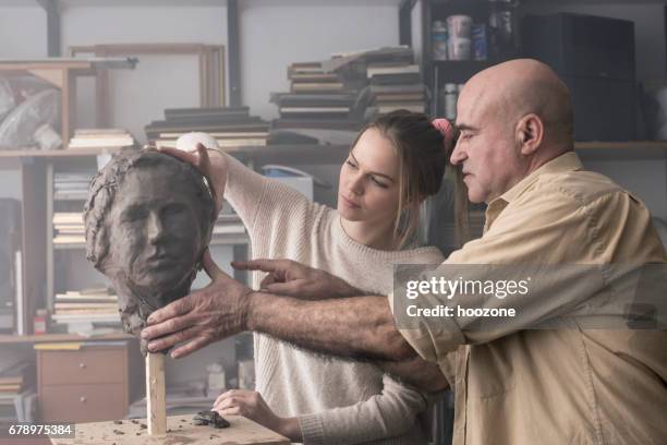 teacher and student sculpting clay face - carving sculpture stock pictures, royalty-free photos & images