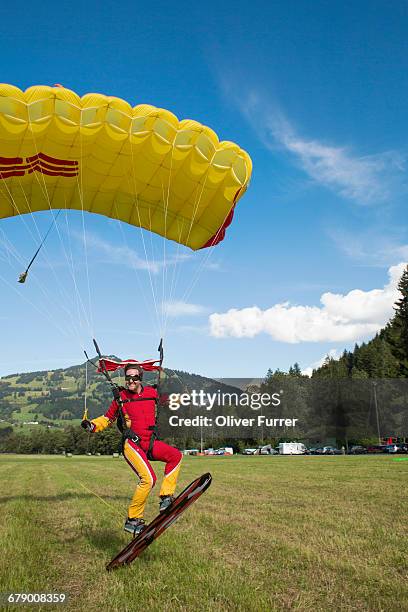 skysurfer is landing his parachute on his board. - skydiving pov stock pictures, royalty-free photos & images