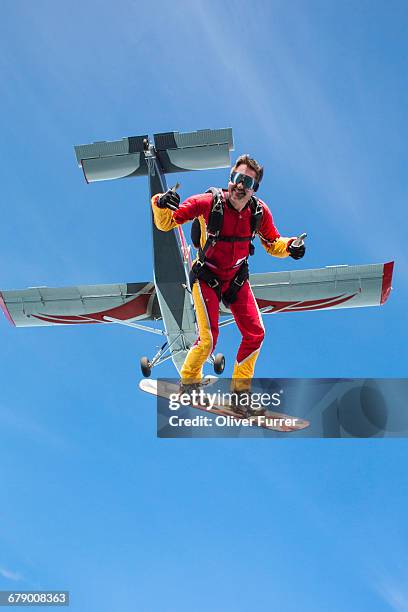 man on a sky board jumped from a plan and smiles. - skydiving pov stock pictures, royalty-free photos & images