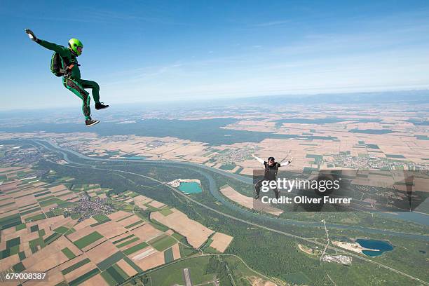 skydiving freefly jumpers are training the sit fly - skydiving pov stock pictures, royalty-free photos & images