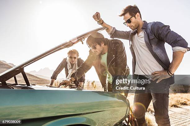 three male friends on roadside checking under car bonnet, franschhoek, south africa - toyota south africa motors stock pictures, royalty-free photos & images