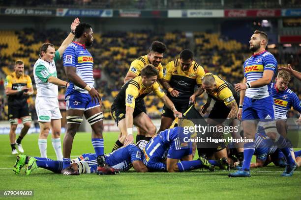 To R, Ardie Savea, Beauden Barrett, Vince Aso and TJ Perenara of the Hurricanes celebrate the try of Julian Savea during the round 11 Super Rugby...