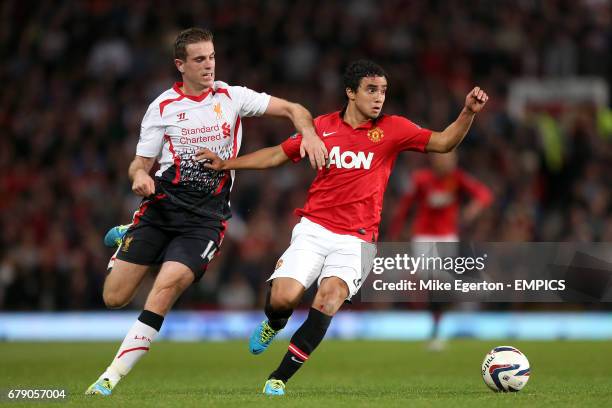 Manchester United's Rafael Da Silva and Liverpool's Jordan Henderson battle for the ball