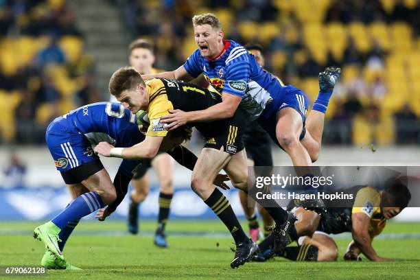 Jordie Barrett of the Hurricanes is tackled by Robert du Preez of the Stormers during the round 11 Super Rugby match between the Hurricanes and the...