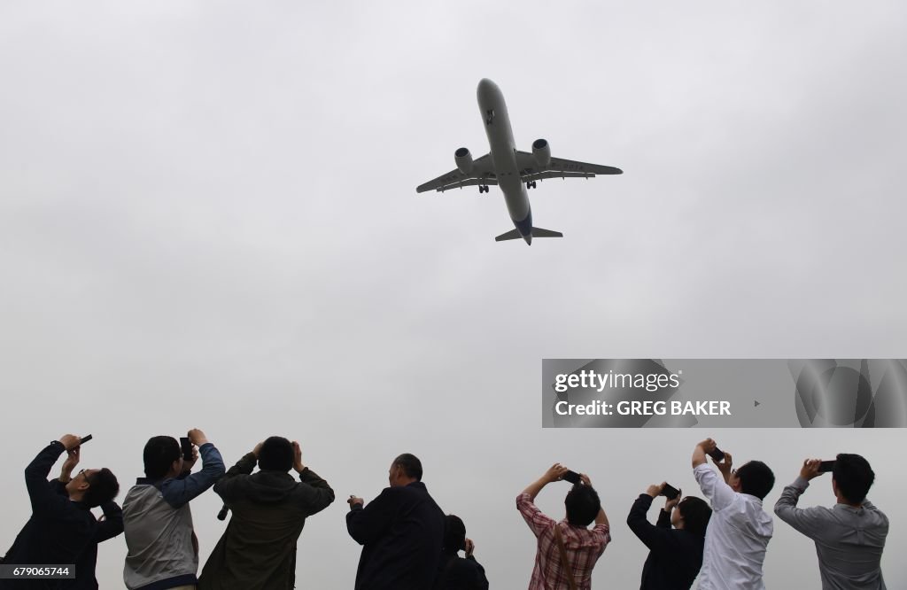 Comac Crash Spectators take photos as they watch the Comac C919, China's first ...