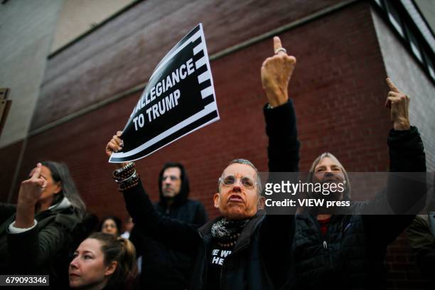 May 04: Activists give the middle finger as they take part in a protest near the USS Intrepid where U.S. President Donald Trump is hosting the visit...