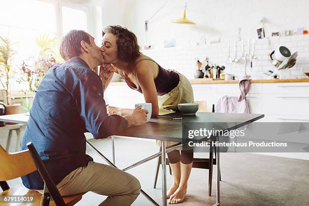 mature couple kisses - couple breakfast bildbanksfoton och bilder