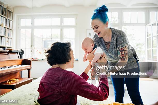 grandmother with her grandson and her daughter - first grandchild stock pictures, royalty-free photos & images