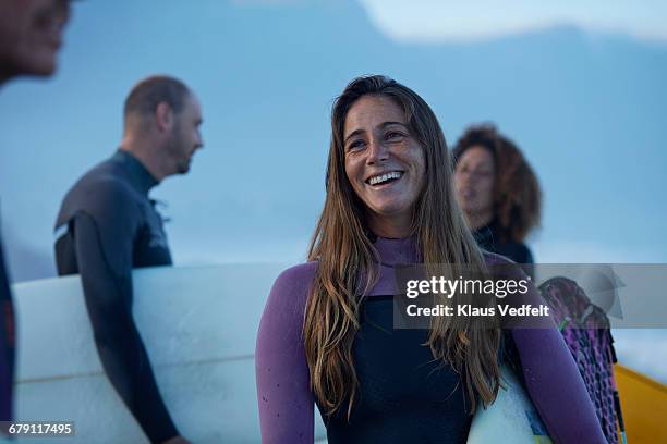 surfers laughing on the beach - wetsuit stock pictures, royalty-free photos & images