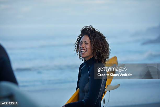 surfer laughing on the beach - surfing stock-fotos und bilder
