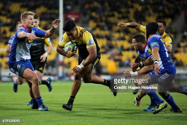 Julian Savea of the Hurricanes breaks the Stormers defence on his way to scoring a try during the round 11 Super Rugby match between the Hurricanes...