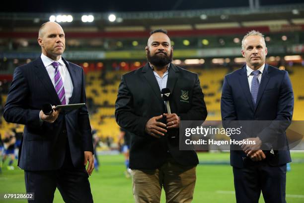 Sky presenters Jeff Wilson and Christian Cullen , along with Hurricanes Loni Uhila look on during the round 11 Super Rugby match between the...