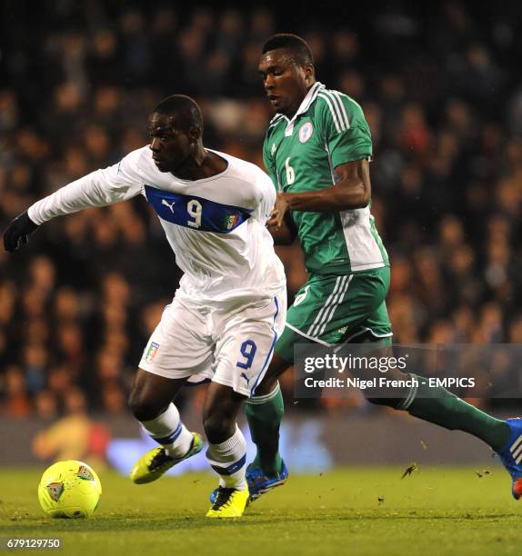 Italy's Mario Balotelli and Nigeria's Azubuike Egwuekwe battle for the ball.