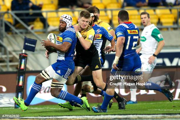 Jordie Barrett of the Hurricanes tackles Nizaam Carr of the Stormers before scoring a try during the round 11 Super Rugby match between the...