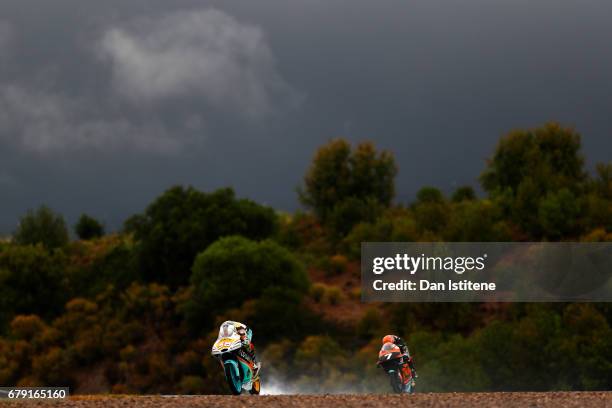 Juanfran Guevara of Spain and the RBA BOE Racing Team rides ahead of Adam Norrodin of Malaysia and the SIC Racing Team during free practice for Moto3...