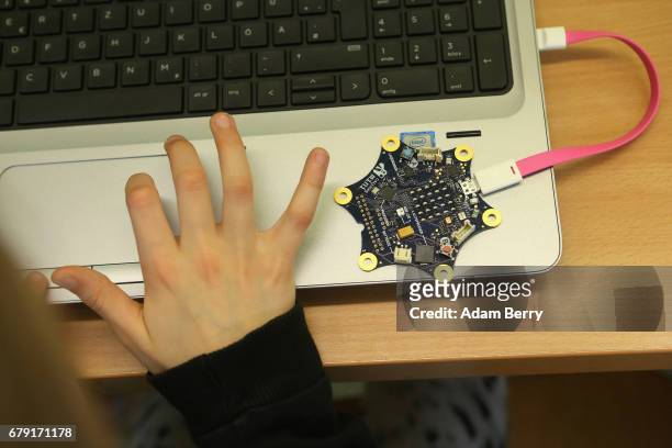 Child uses a "Calliope mini" computer during a demonstration of the device on May 5, 2017 in Berlin, Germany. The USB-connected circuit board,...