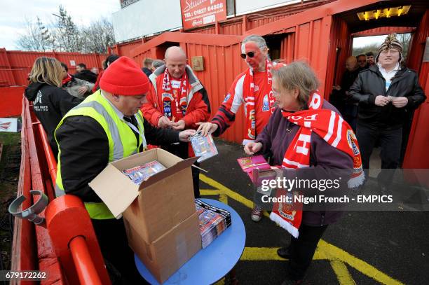 Tamworth fans purchase match day programmes before the game against Bristol City