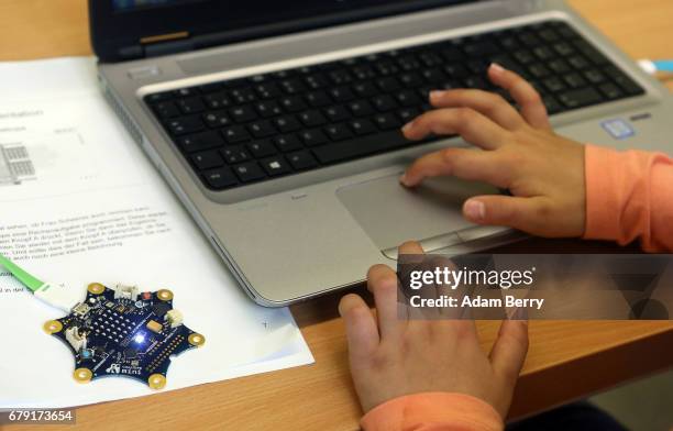 Child uses a "Calliope mini" computer during a demonstration of the device on May 5, 2017 in Berlin, Germany. The USB-connected circuit board,...
