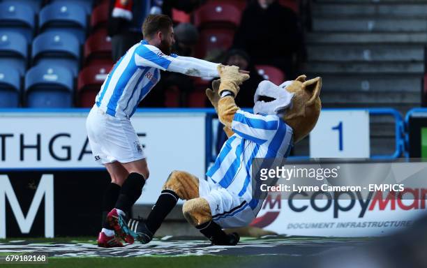 Huddersfield Town's Adam Clayton pushes over the club mascot after scoring the first goal