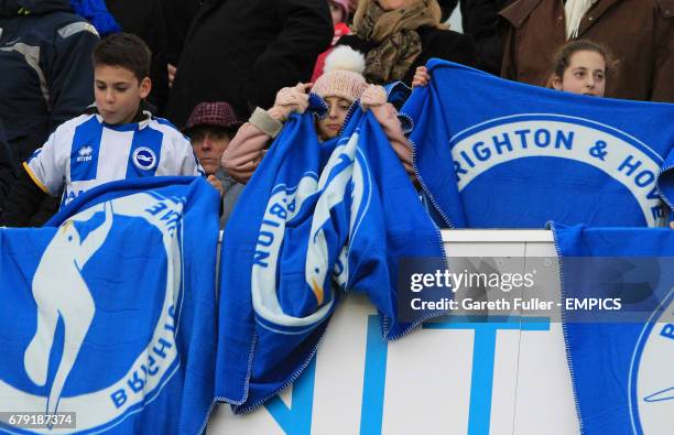 Young Brighton & Hove Albion fans set out their flags before the match against Bournemouth.