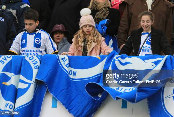 Young Brighton & Hove Albion fans set out their flags before the match against Bournemouth.