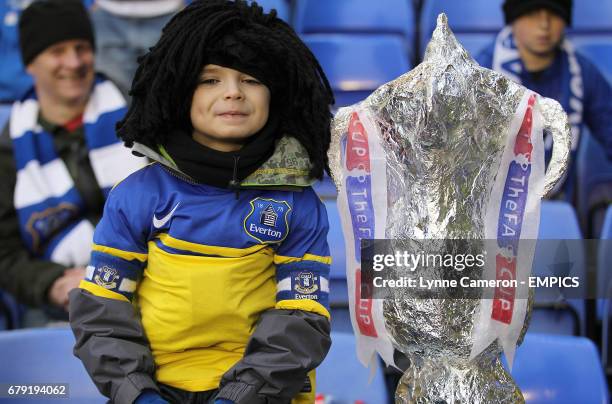 An Everton fan with a home-made FA Cup trophy in the stands