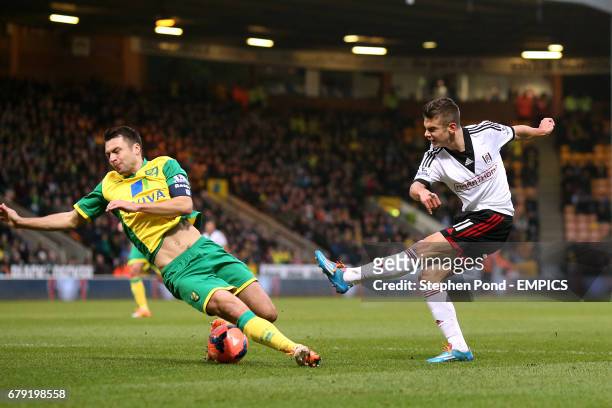 Norwich City's Russell Martin charges down a shot by Fulham's Alex Kacaniklic