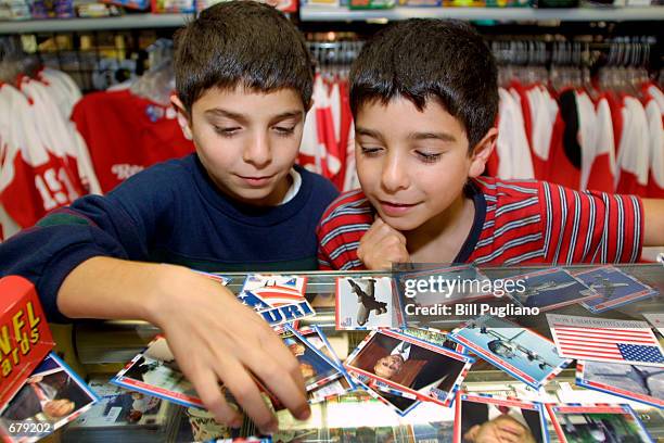 Twins Jeremy and Julian Katty, age 9, sort through a pile of the new Topps "Enduring Freedom" patriotic cards November 2, 2001 at Sports Cards City...