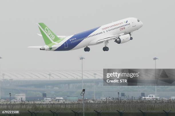 China's home-grown C919 passenger takes off on its maiden flight at Pudong International Airport in Shanghai on May 5, 2017. The first large...