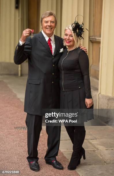 Singer Marty Wilde with his daughter Kim poses with his MBE medal from Queen Elizabeth II at an Investiture ceremony at Buckingham Palace on May 5,...