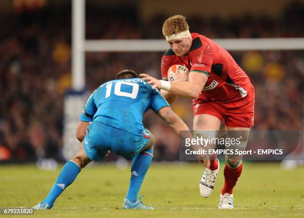 Wales' Andrew Coombs is tackled by Italy's Tommaso Allan