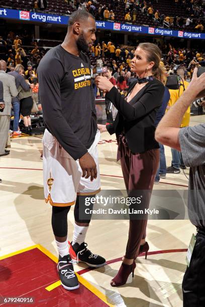 LeBron James of the Cleveland Cavaliers talks to NBA TNT Analyst, Kristen Ledlow after Game Two of the Eastern Conference Semifinals against the...