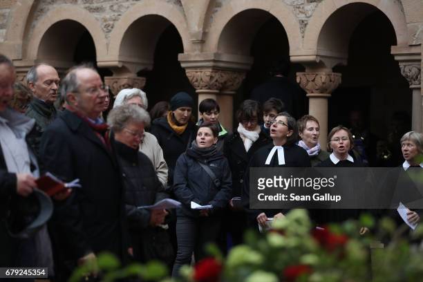 Worshippers and Protestant clergy members sing during an open-air religiousservice at Wartburg Castle to commemorate the May 4 arrival of Martin...