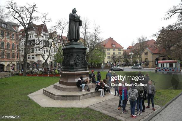 Schoolchildren stand next to a statue of Martin Luther, whose 95 theses of 1517 set in motion the Reformation, in the city center on May 5, 2017 in...