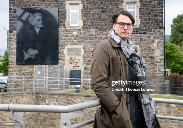 Artist Gregor Hildebrandt pictured in front of his work of art 'Und mir unendlich fern ' on May 5, 2017 in Bingen, Germany. The work is part of the...